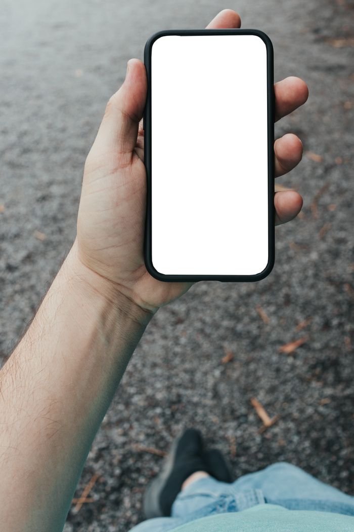 A hand holding up a phone, ready to open a link