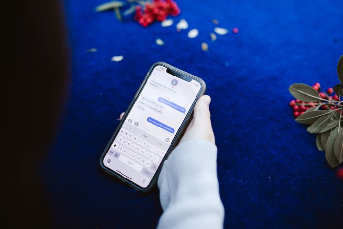 A hand holding a phone showing text messages